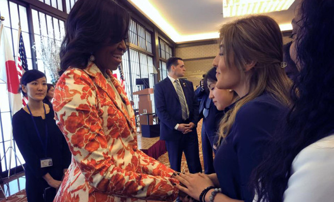 Photo: first lady Michelle Obama shaking hands with TUJ student