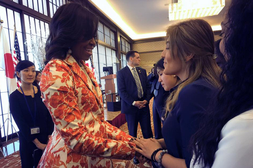 Photo: first lady Michelle Obama shaking hands with TUJ student
