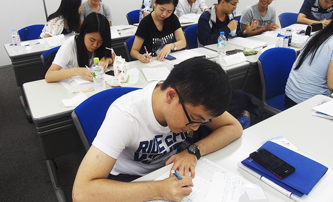 Photo: Pang Shih-Chun (NTPU real estate major) working on a final class assignment