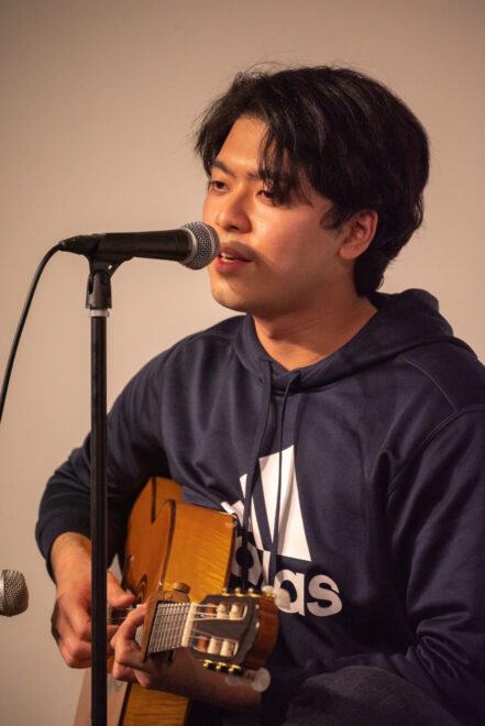 An original song performance by student performer Koshi Amagasa