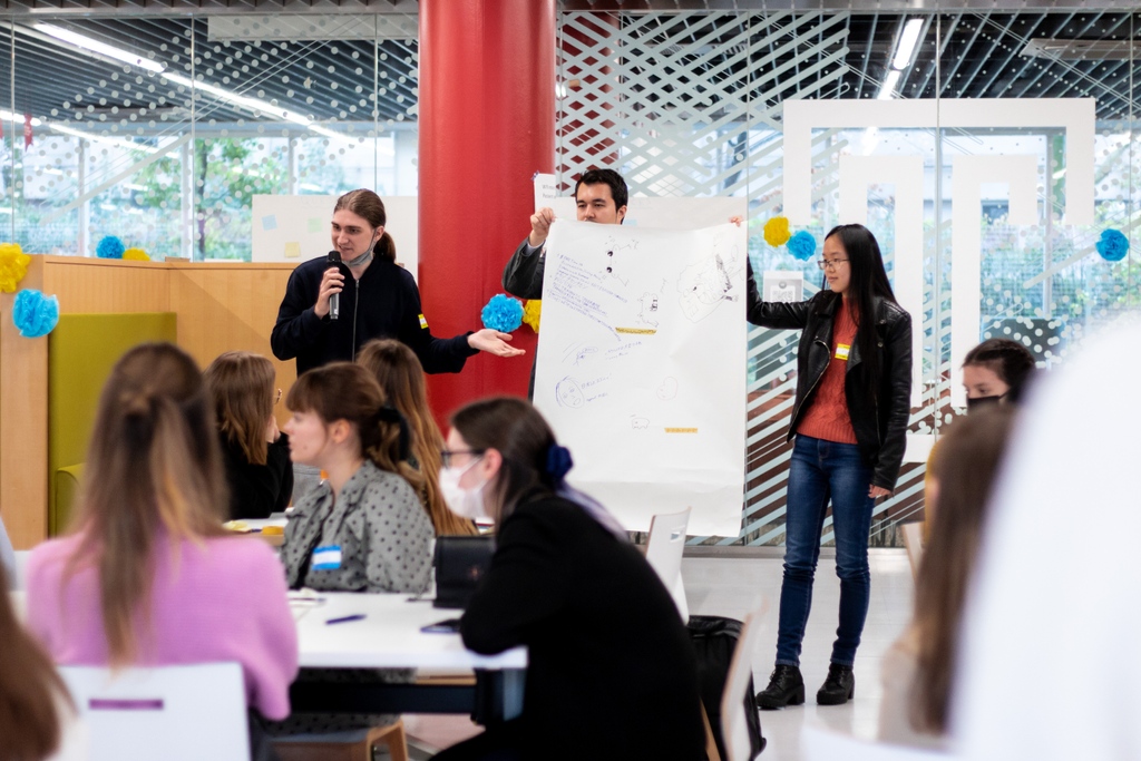 Students make presentations after a networking session in TUJ's cafeteria. Photo by William Galopin