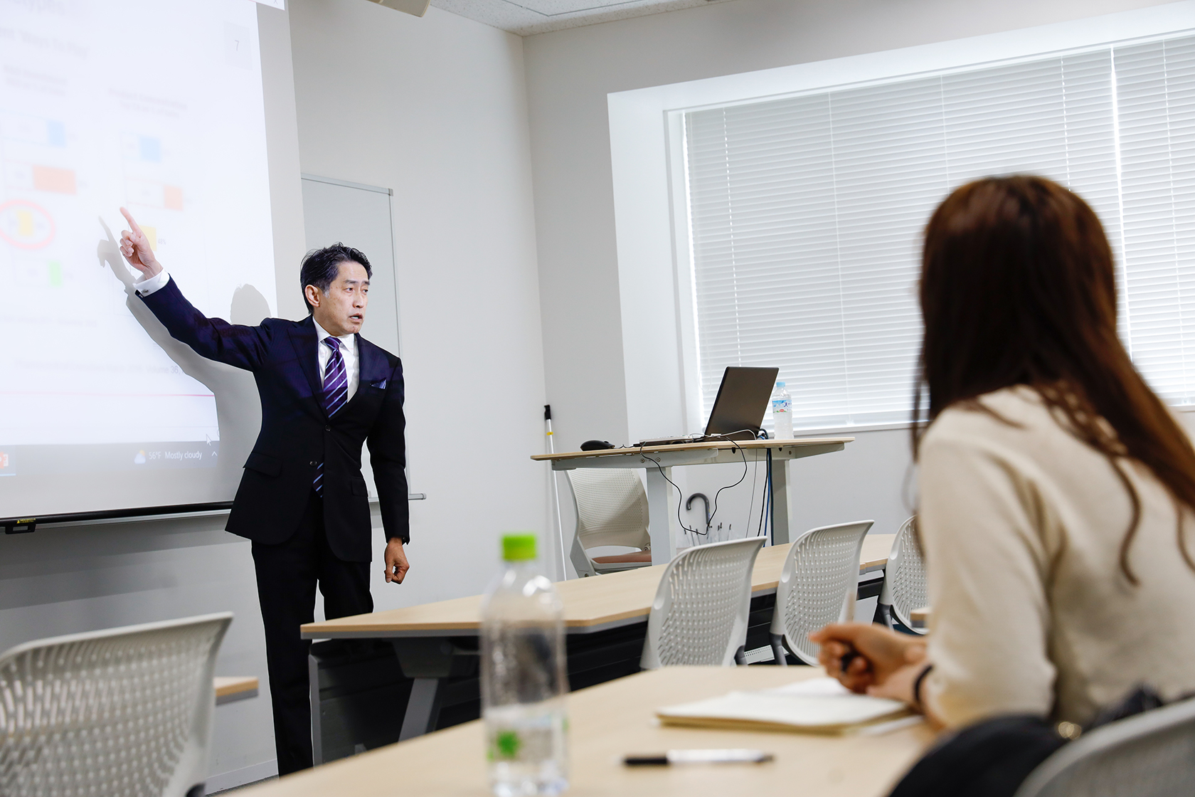 Astellas President Naoki Okamura delivers a lecture to students on TUJ campus