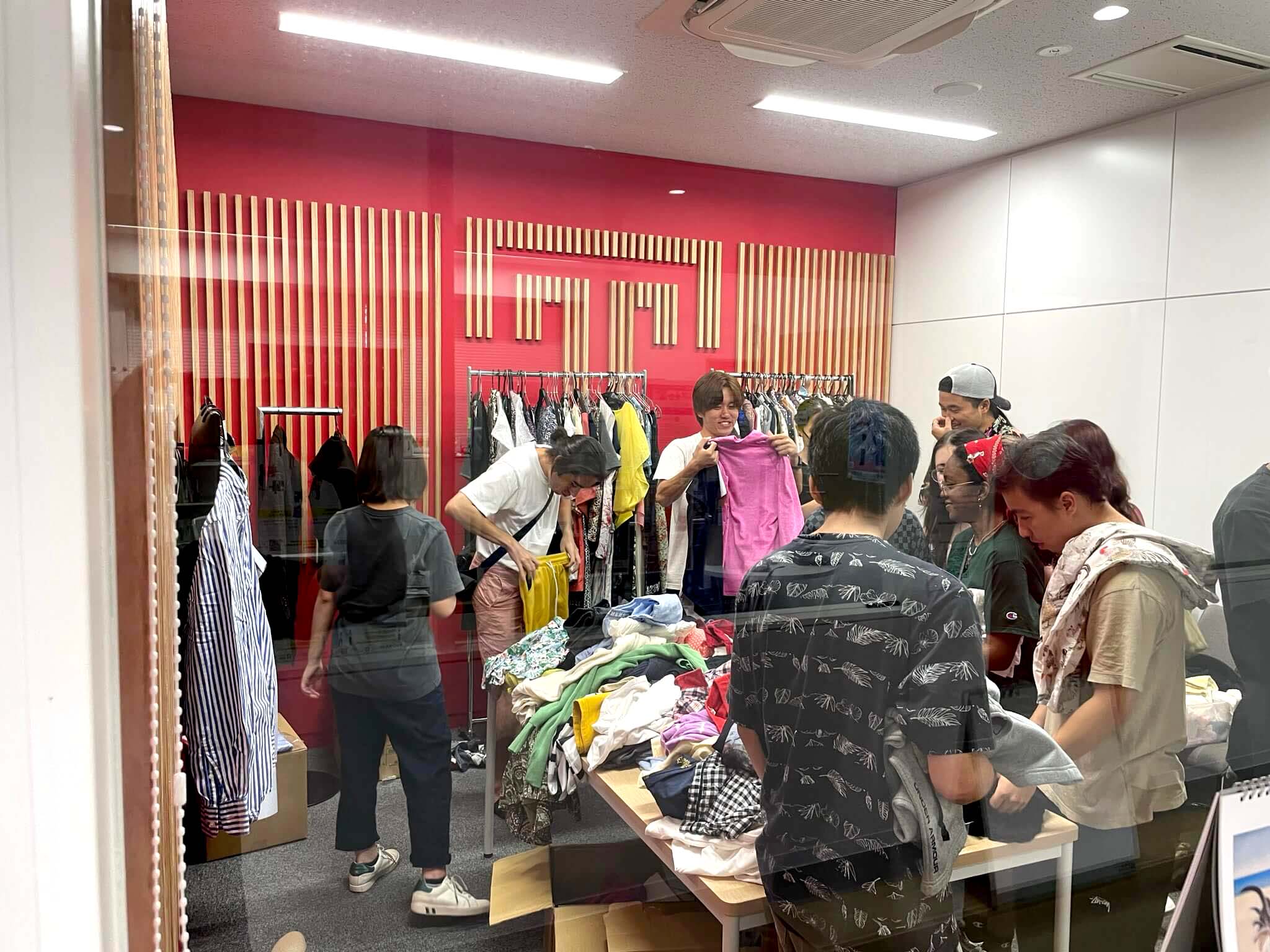 TUJ students selecting clothes during the clothing donation campaign in TUJ’s Welcome Room