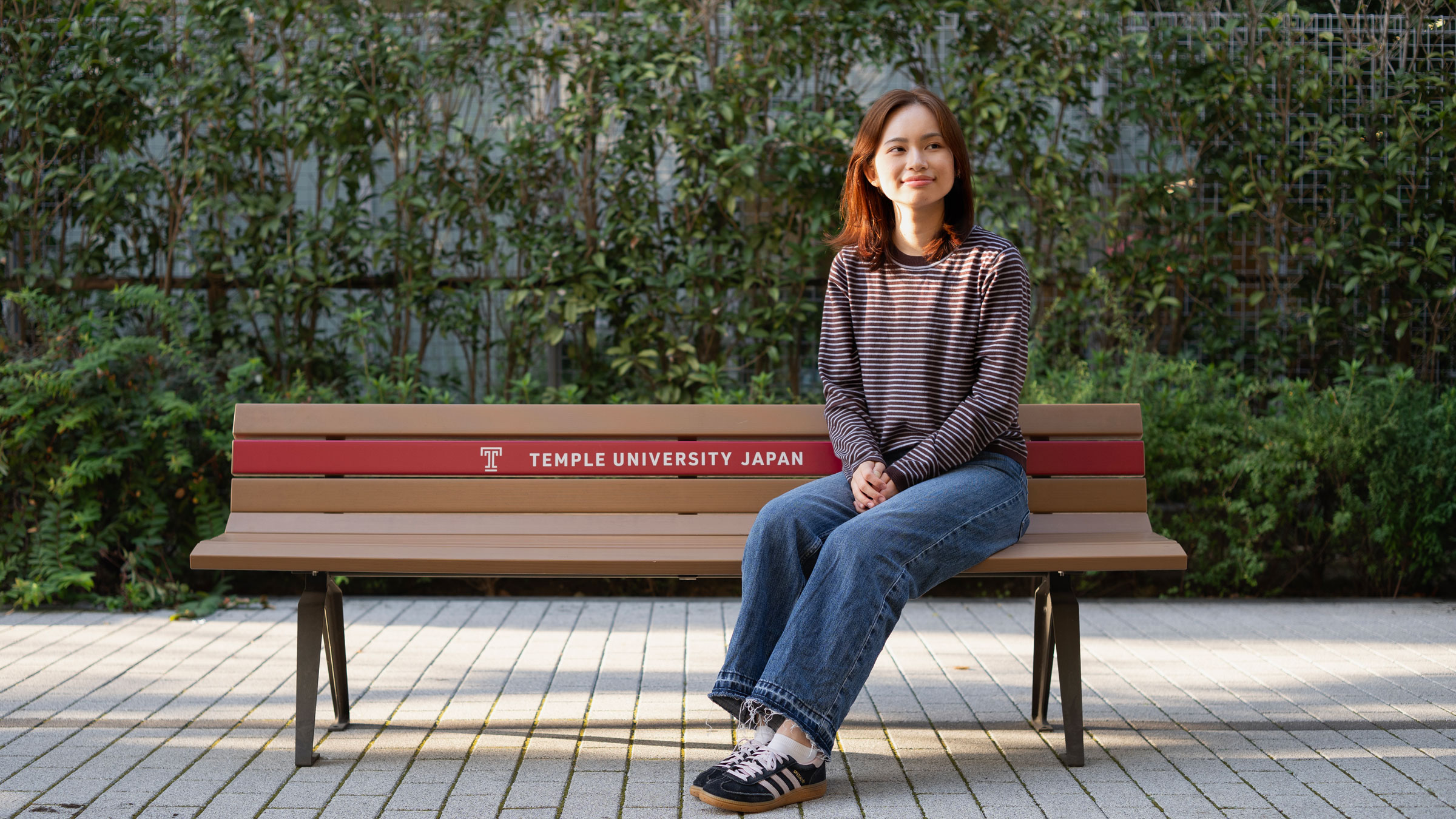 a TUJ sophomore sitting in TUJ bench