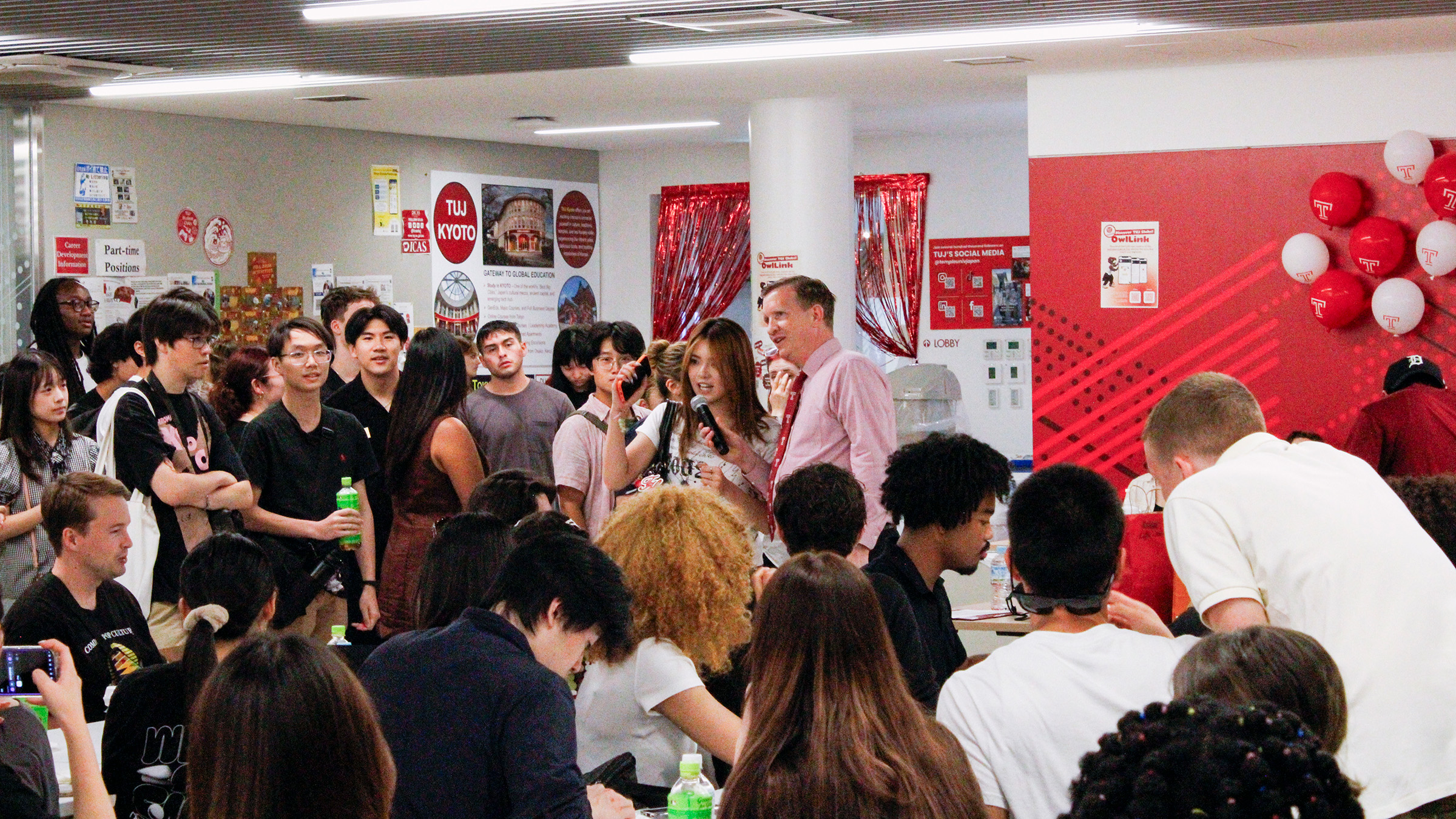 An image of welcome week reception at TUJ with students and the Dean